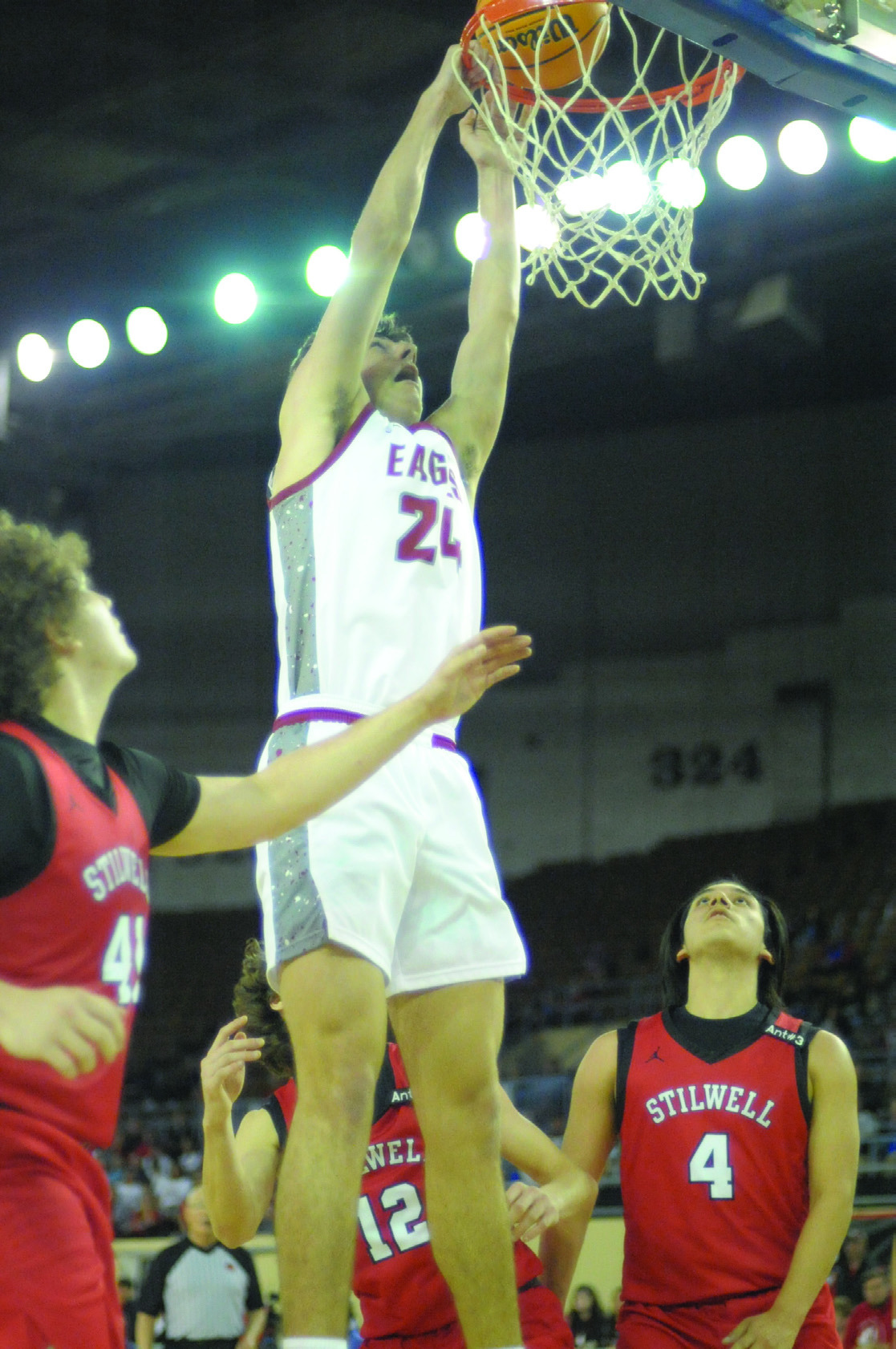 Tate Sage dunks the ball during Thursday’s game against Stilwell. He scored 12 points the game. Josh Burton/WDN