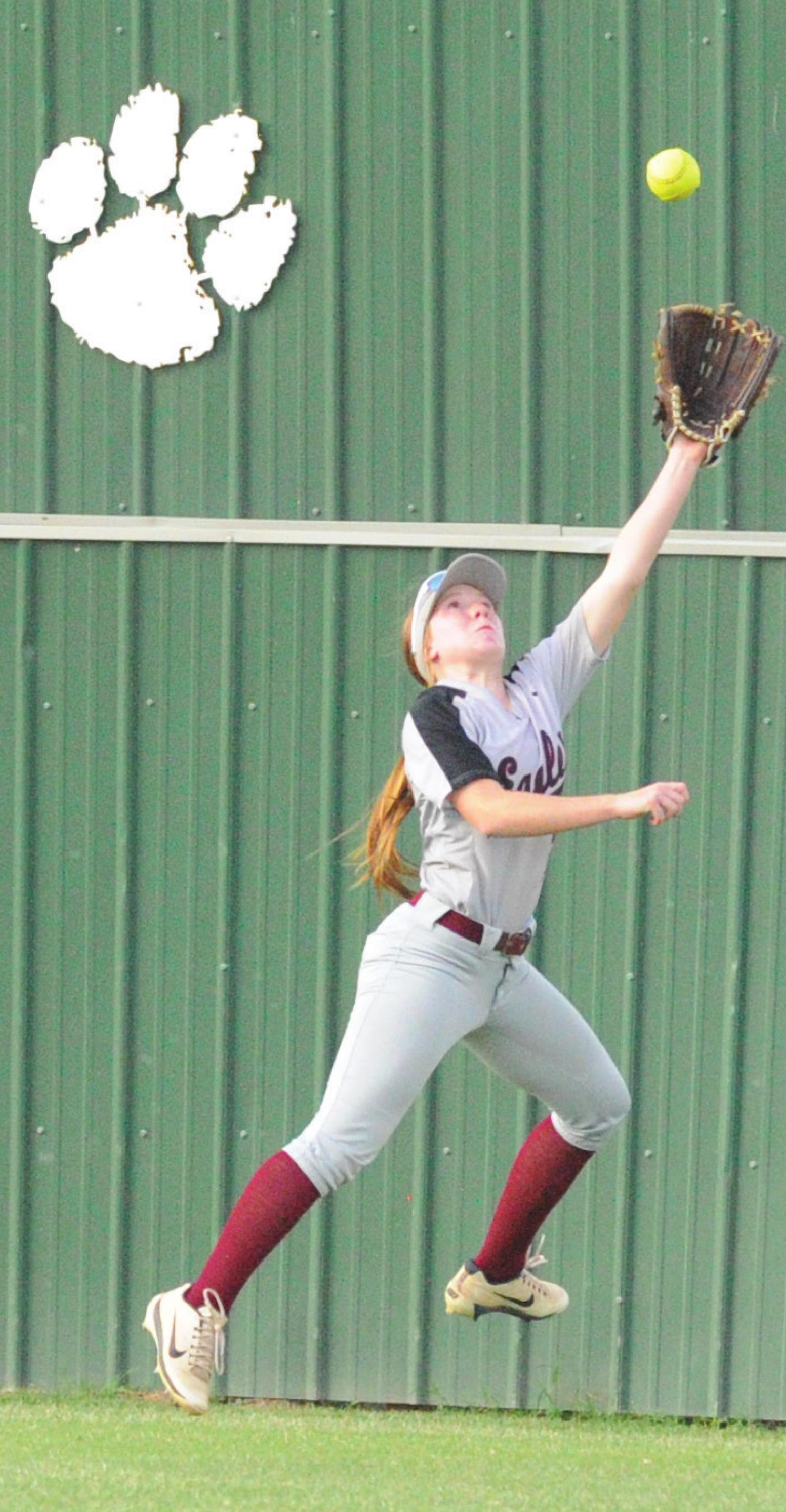 At left, Megan Mills looks up for the ball in center field in Tuesday’s game at Tuttle. Josh Burton/WDN