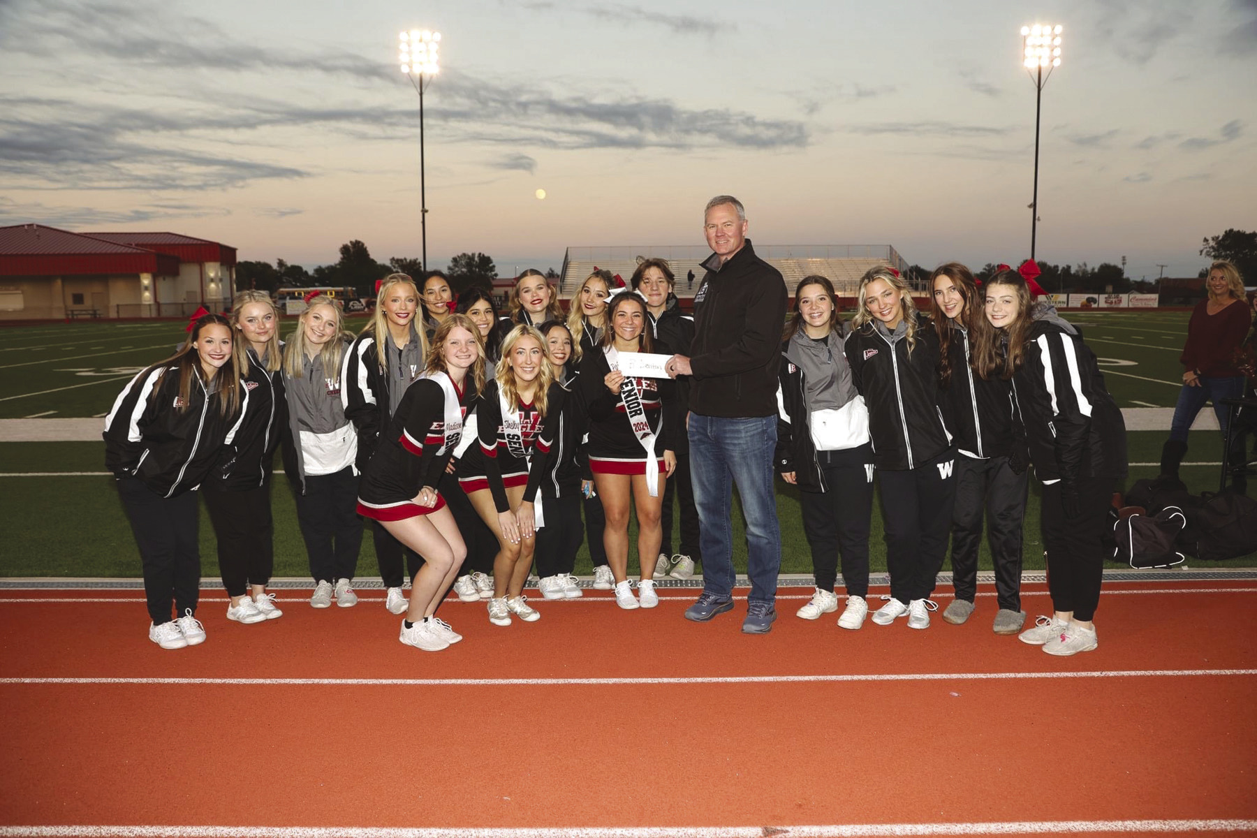 Weatherford cheerleaders raised more than $2,300 and presented a check during Weatherford’s football game Friday night. Photo by Steve Wheeler