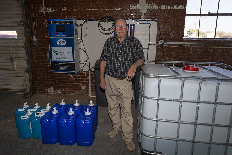 SWOSU Safety & Compliance Coordinator Rick Dahlgren stands with the machine and supplies that make hypochlorous acid, which is being used to disinfect rooms and buildings. The product is available for pickup now in Clinton and Elk City and by December 14 in Weatherford.