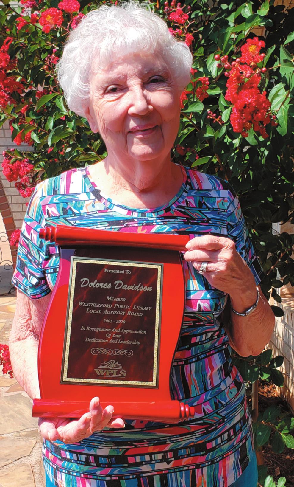 Dolores Davidson shows off the plaque commemorating her service with the Weatherford Public Library Local Advisory Board. Leanna Cook/WDN
