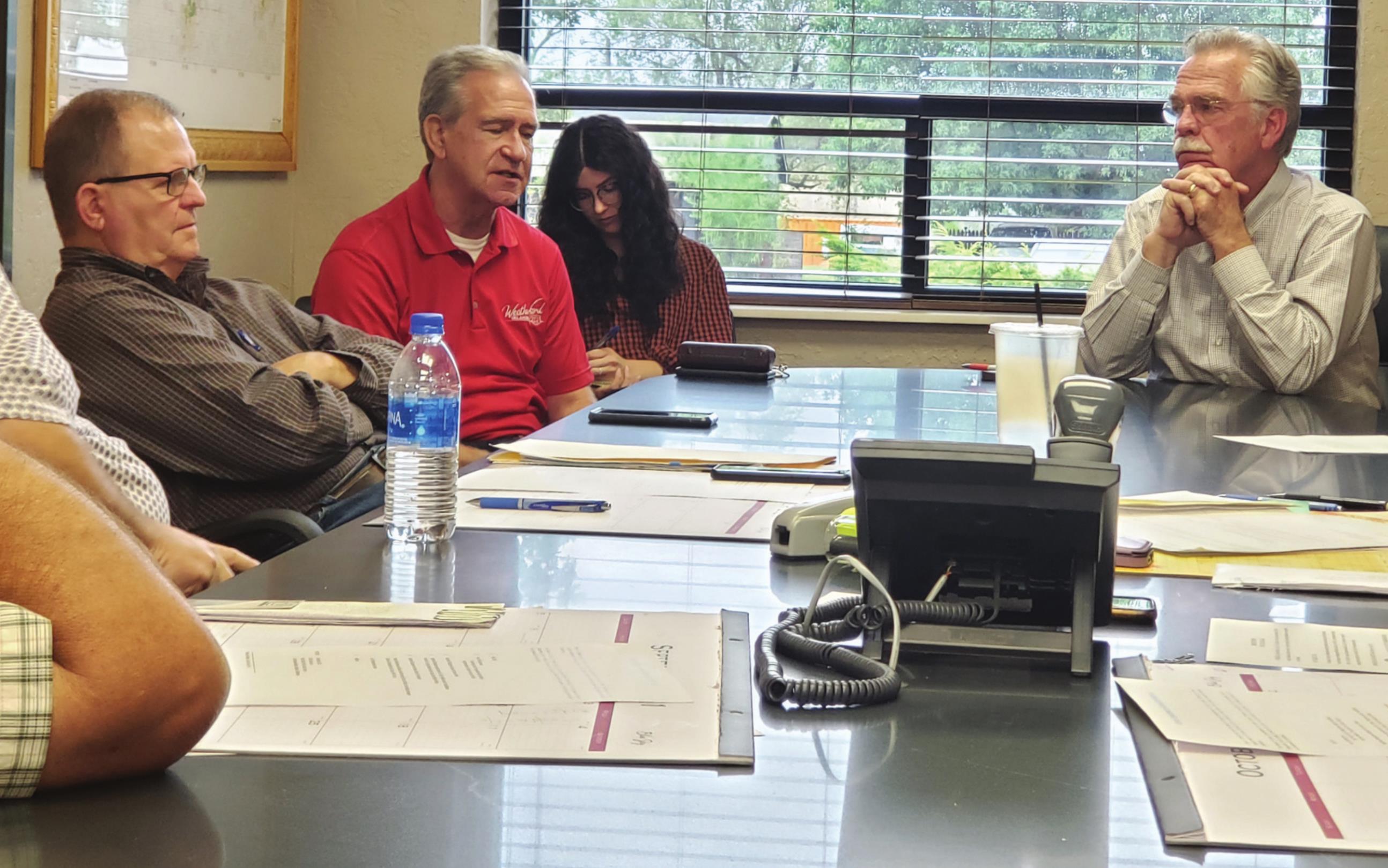 Leanna Cook/WDN Weatherford Mayor Mike Brown and Clinton Mayor David Berrong discuss the water line feasibility study during the county commission meeting Tuesday morning.