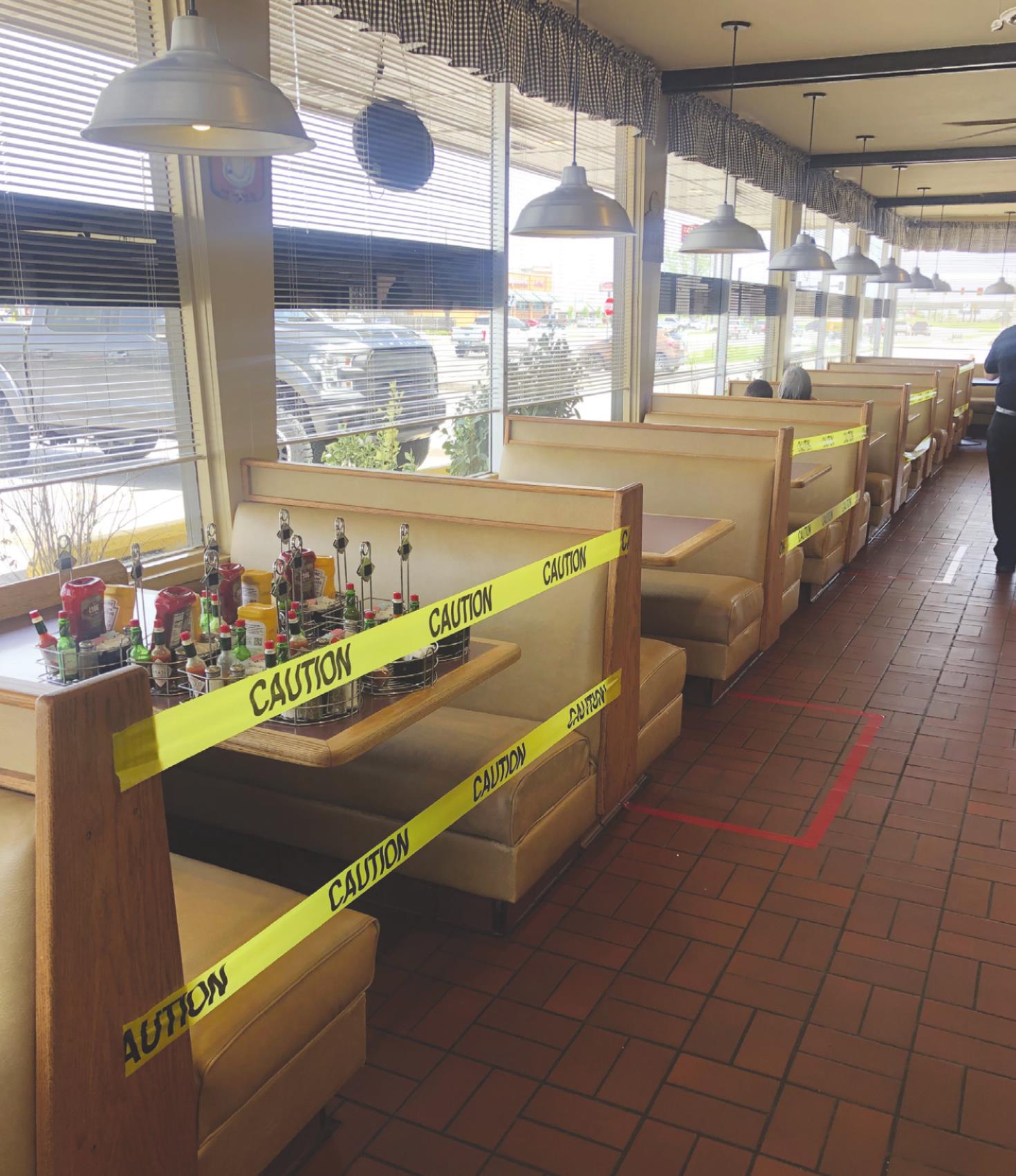 In order to keep customers and staff safe, Jerry’s Restaurant has every other booth taped off, has newly sanitized condiments available for each customer and has taped off areas for wait staff to serve customers from a distance. Harlie Cloyd/WDN