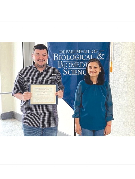 Colter Esparza is pictured with the certificate he received for his presentation at Research Day at the Oklahoma State Capitol. He is standing with Dr. Pragya Sharma.