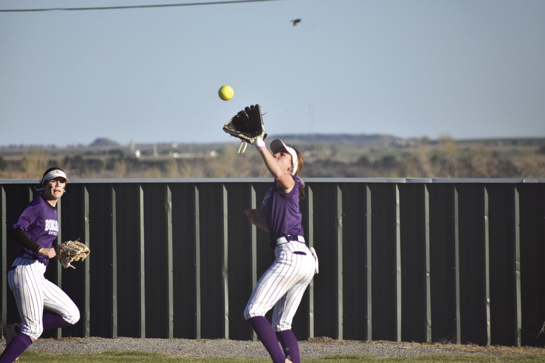 Lexie Schmidt, right, catches a pop fly during Hydro-Eakly’s game Thursday against Arapaho-Butler. Mondi Parker/WDN