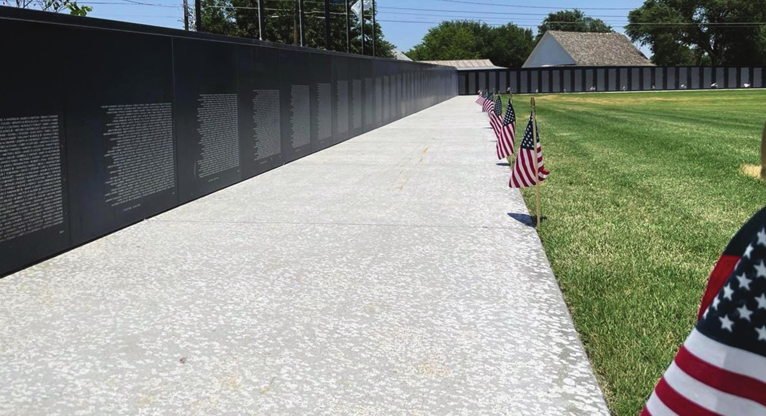 The newly built Vietnam Veterans Memorial replica wall stands in Weatherford’s Heritage Park. A group of Vietnam veterans joined community members in attending the dedication of the wall Saturday morning. Montgomery Malone/WDN