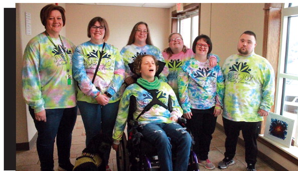 Director Kim Steinly and artists Breanne Bell, Danica Suderman, in front, Shay Renfro, Justice Carman, Katie Corning and Brayden Reagan smile in their self-made tye-dye Just Joy shirts. Kimberly LIppencott/WDN
