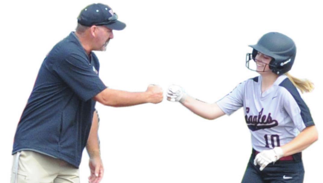 Hunter Bayless fist-bumps her coach Rick Morris after hitting a home run in the first inning Saturday. Josh Burton/WDN