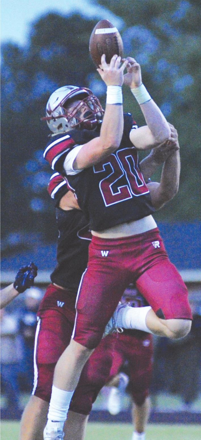 Murphy Beck reaches for a ball he intercepted in Friday’s game between Weatherford and El Reno. Weatherford won the game 41-14. Josh Burton/WDN