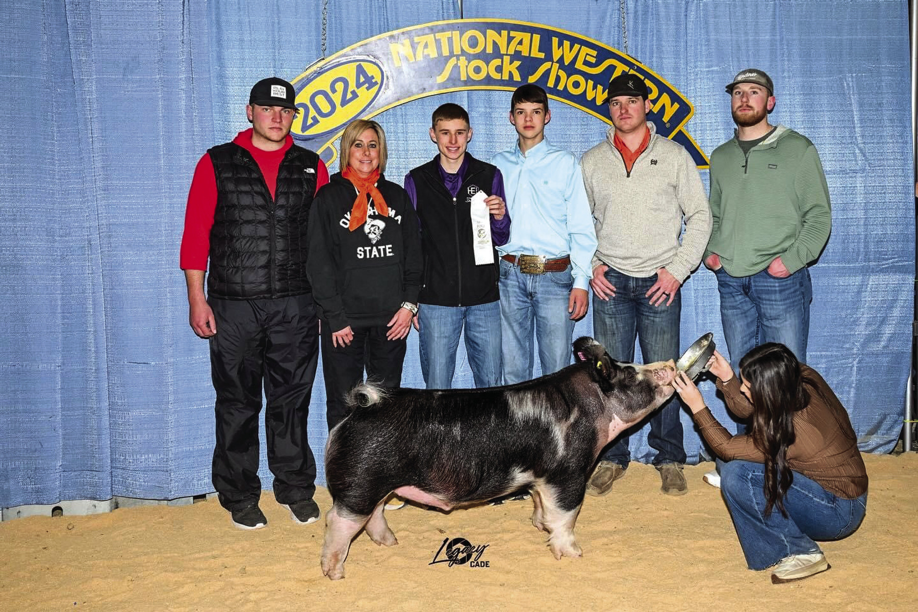 Hydro-Eakly FFA members Crede Woods, third from left, and Kason Proffitt, fourth from left, both showed their barrows this week at the National Western in Denver. Crede was third with his Berkshire barrow while Kason was second with his Crossbred barrow.