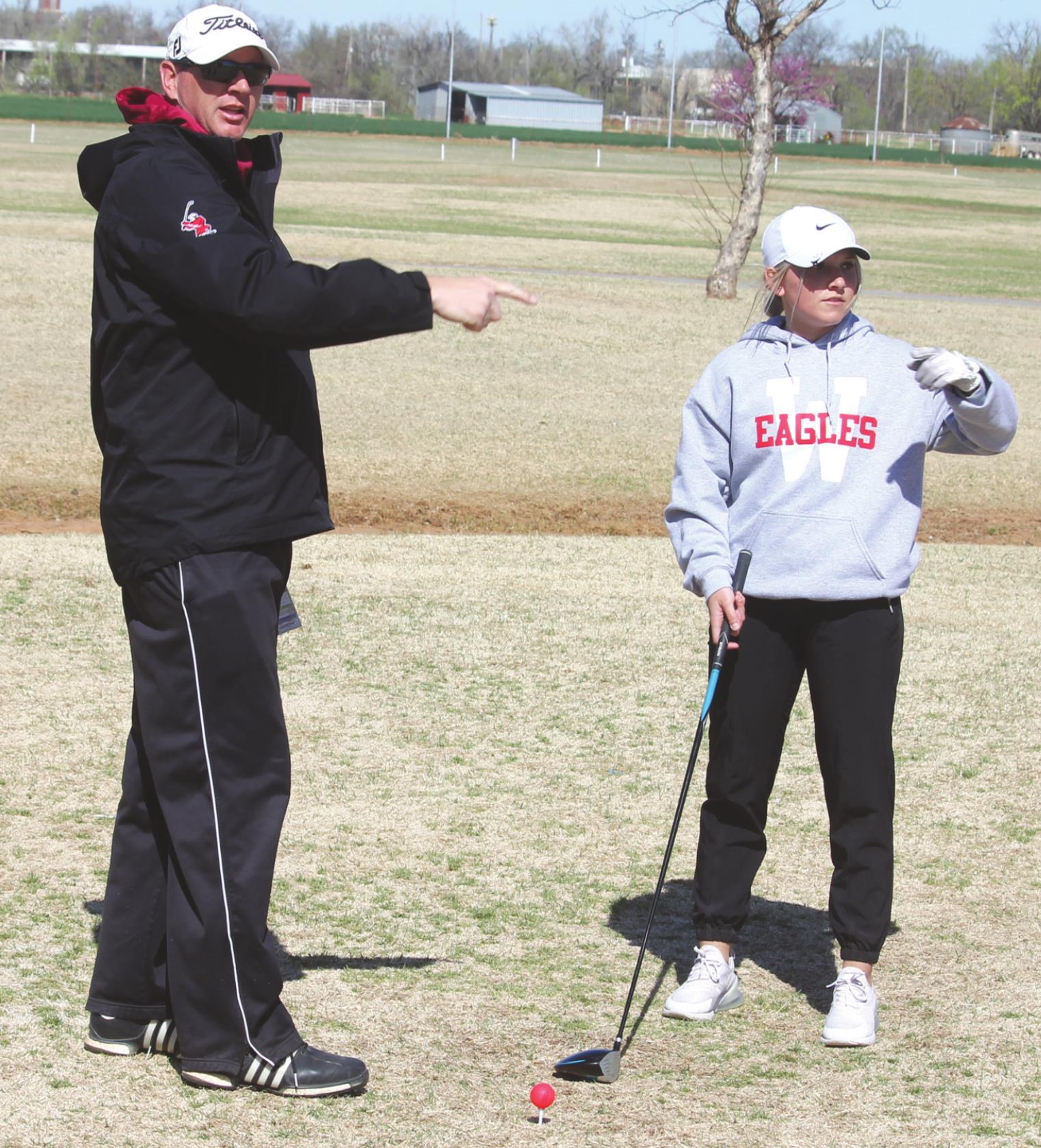 Weatherford coach Kyle Mickley and Kyndall Sage get clarification before Sage hits her tee shot. Josh Jennings/WDN