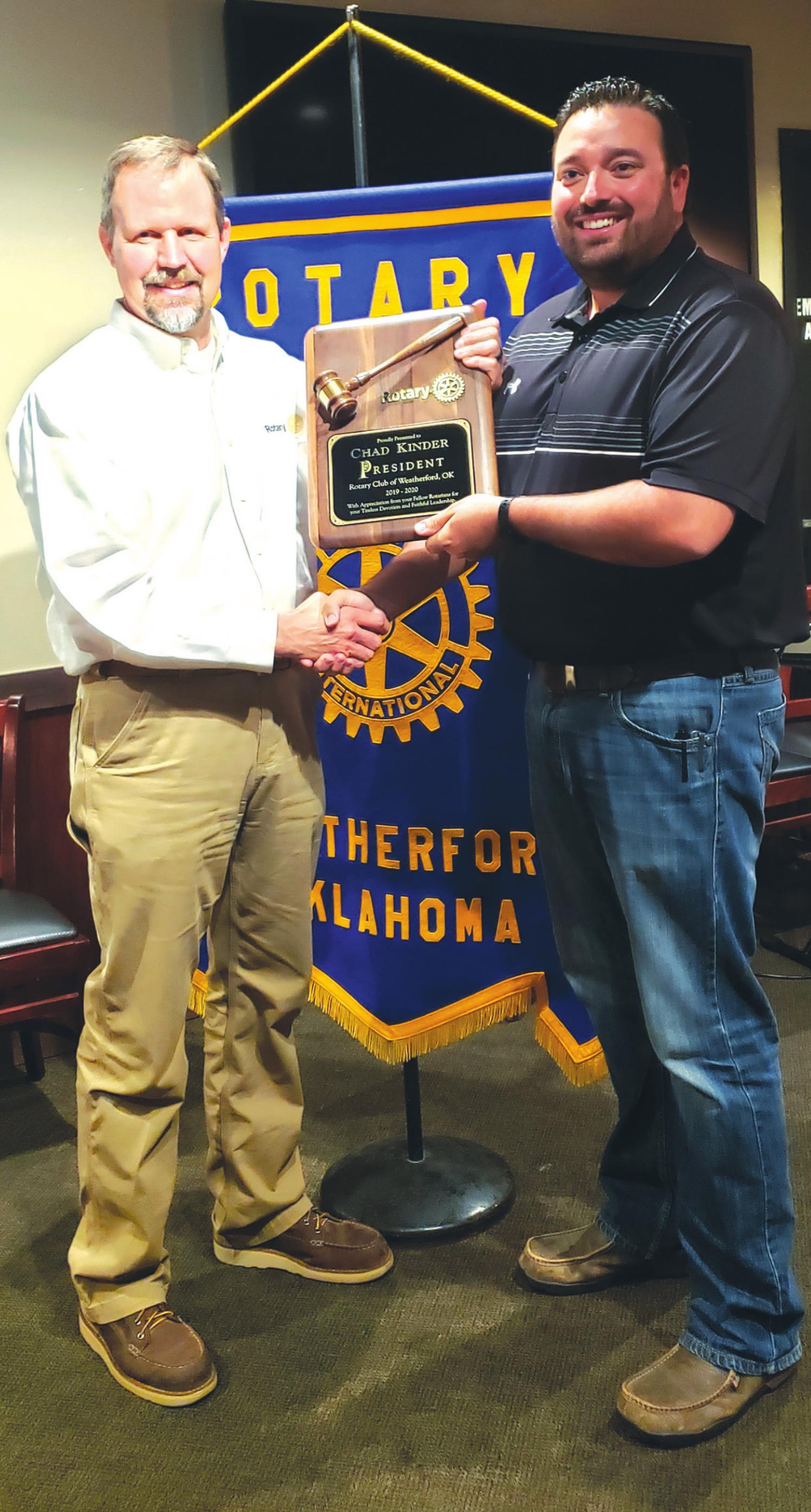 New Weatherford Rotary Club President Todd Earp, right, presents former Rotary Club President Dr. Chad Kinder with a plaque commemorating Kinder’s time as president. Leanna Cook/WDN