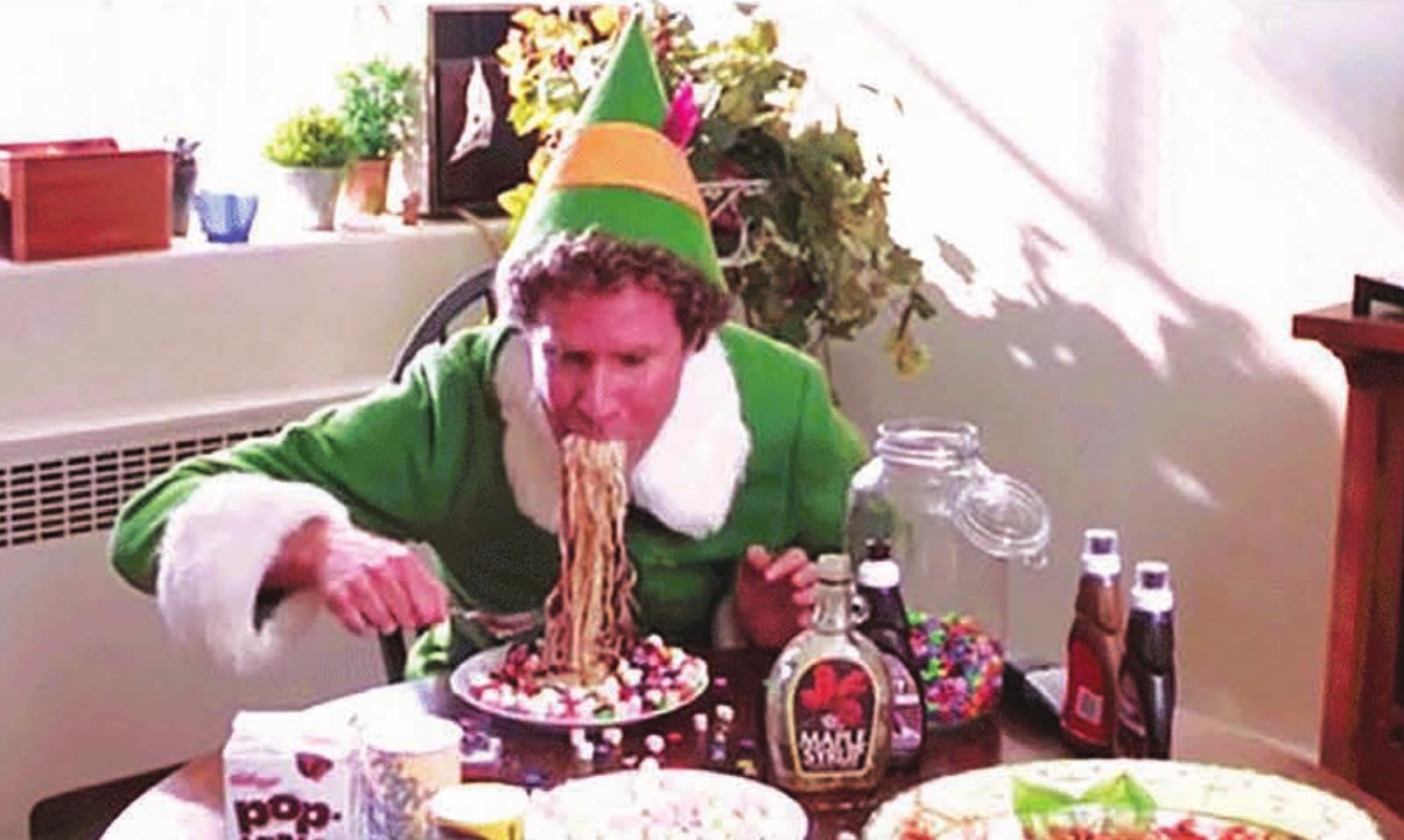 Actor Will Ferrell, who plays Buddy in the movie Elf, is pictured in a scene from the movie eating spaghetti with maple syrup. Photo courtesy of Elf