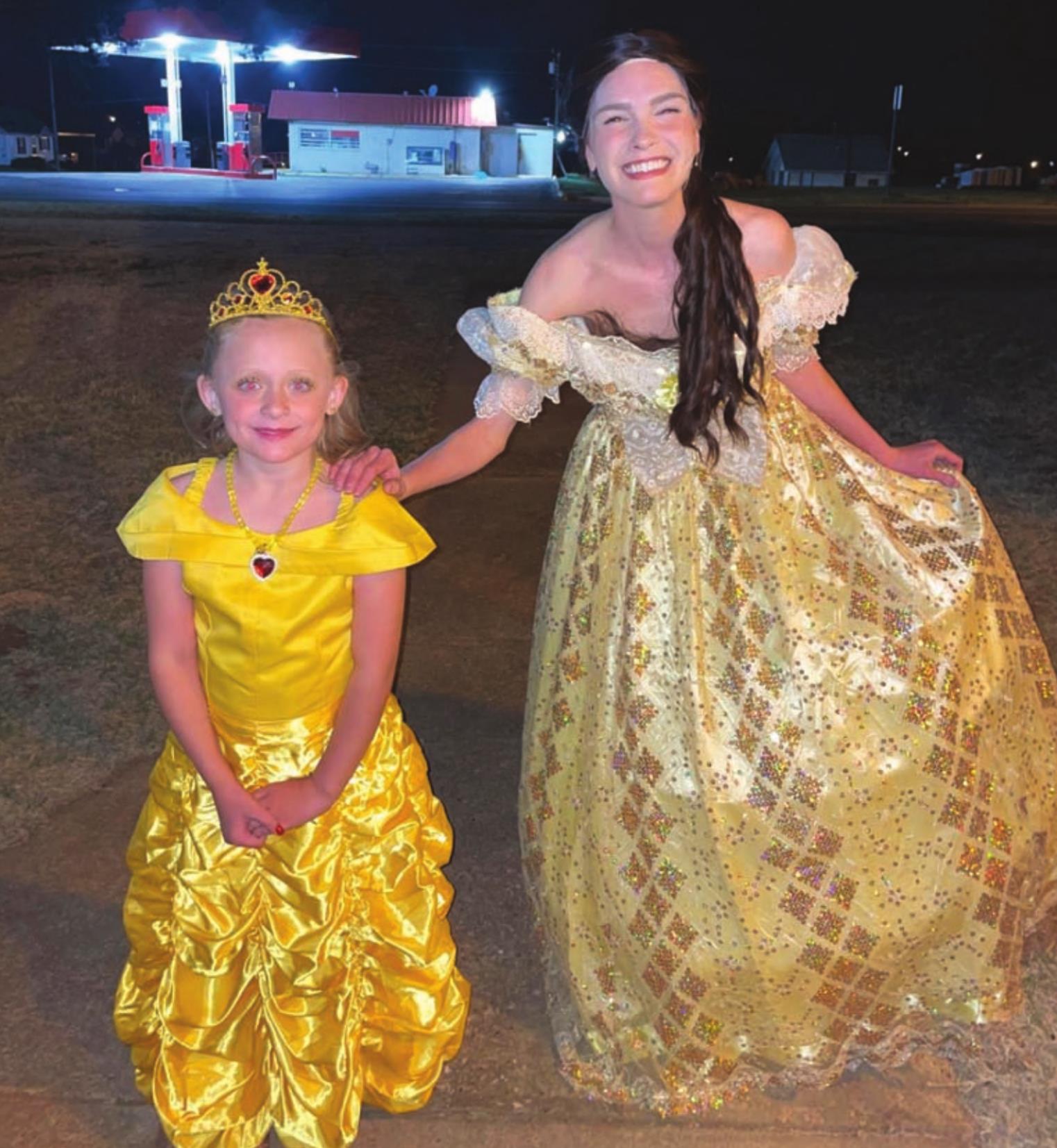 Scarlett Fowble of Thomas poses with Clarissa Berrong after the Thursday performance of Beauty and the Beast. Both wear their Belle gowns. Kimberly Lippencott/WDN
