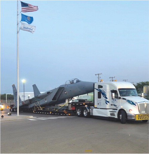 Pictured at left is a semi truck delivering the F-15A Eagle on a trailer to Weatherford. Provided