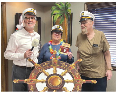 Ashley Adams/WDN Congratulations to the “Winter Wonder Cruise” winners. The WDN is giving away tickets to a five-day Caribbean cruise. Each of the winners gets a free ticket to bring a plus one on the cruise as well. Above, Nicole Parkhurst stands by the wheel after winning a Winter Wonder Cruise. At left, Brenda, middle, and Dennis Williams, stand with WDN Publisher Phillip Reid, left, and wear the captain’s hat after winning the Caribbean vacation for two.