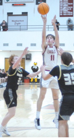 Jackson Smith takes a shot inside the 3point line duirng the District Tournament win against Woodward. Josh Burton/WDN