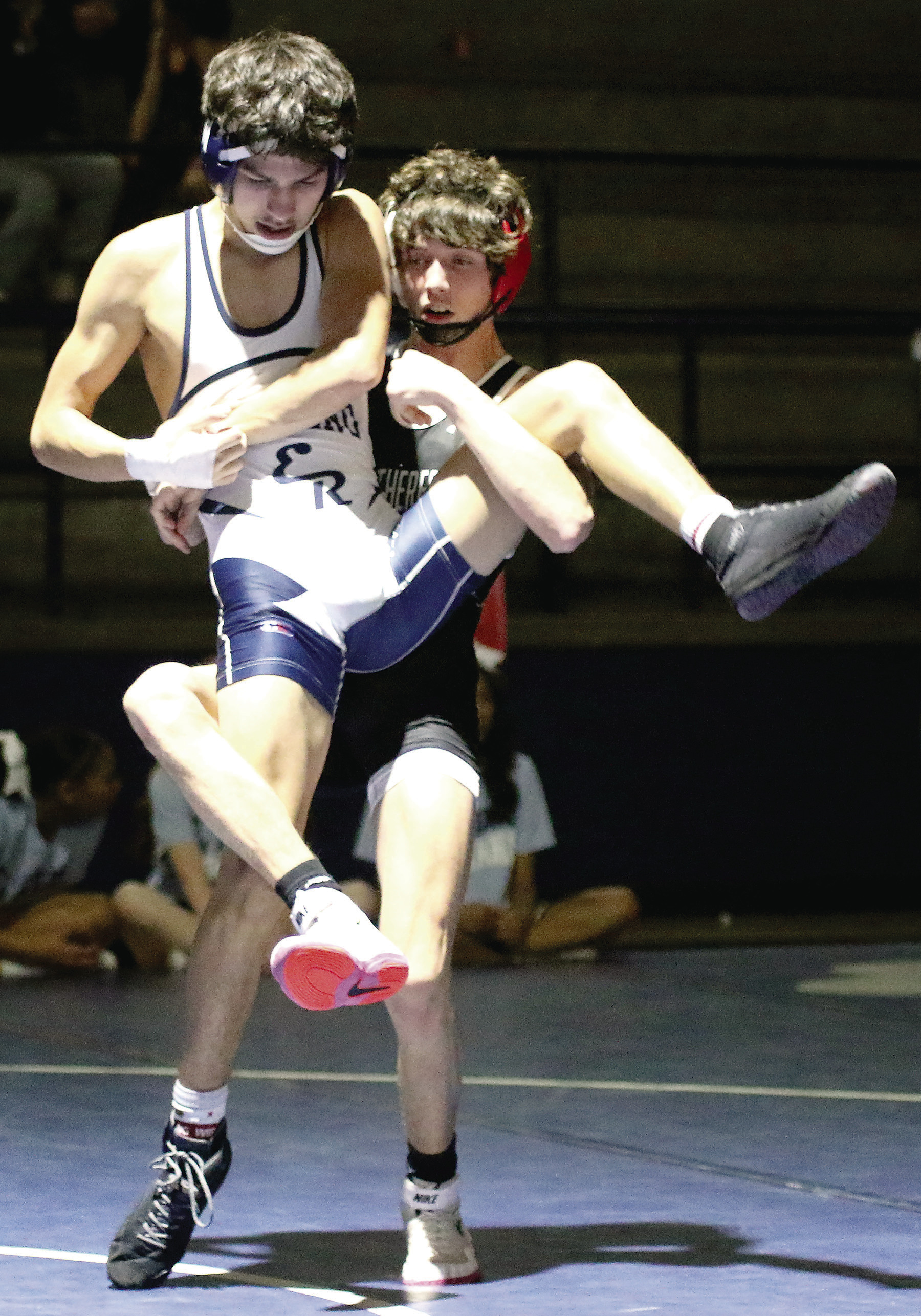 Above, Creek Williams tries to pin his opponent during Tuesday’s dual at El Reno. At left, Dylan Renna lifts his opponent for a possible takedown during Weatherford’s dual at El Reno.