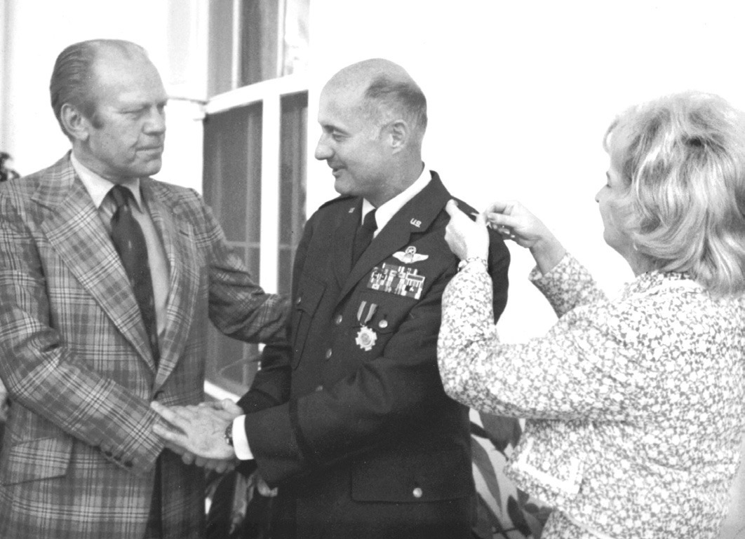 Stafford is congratulated by President Gerald Ford as he receives his General pin from his wife, Faye.