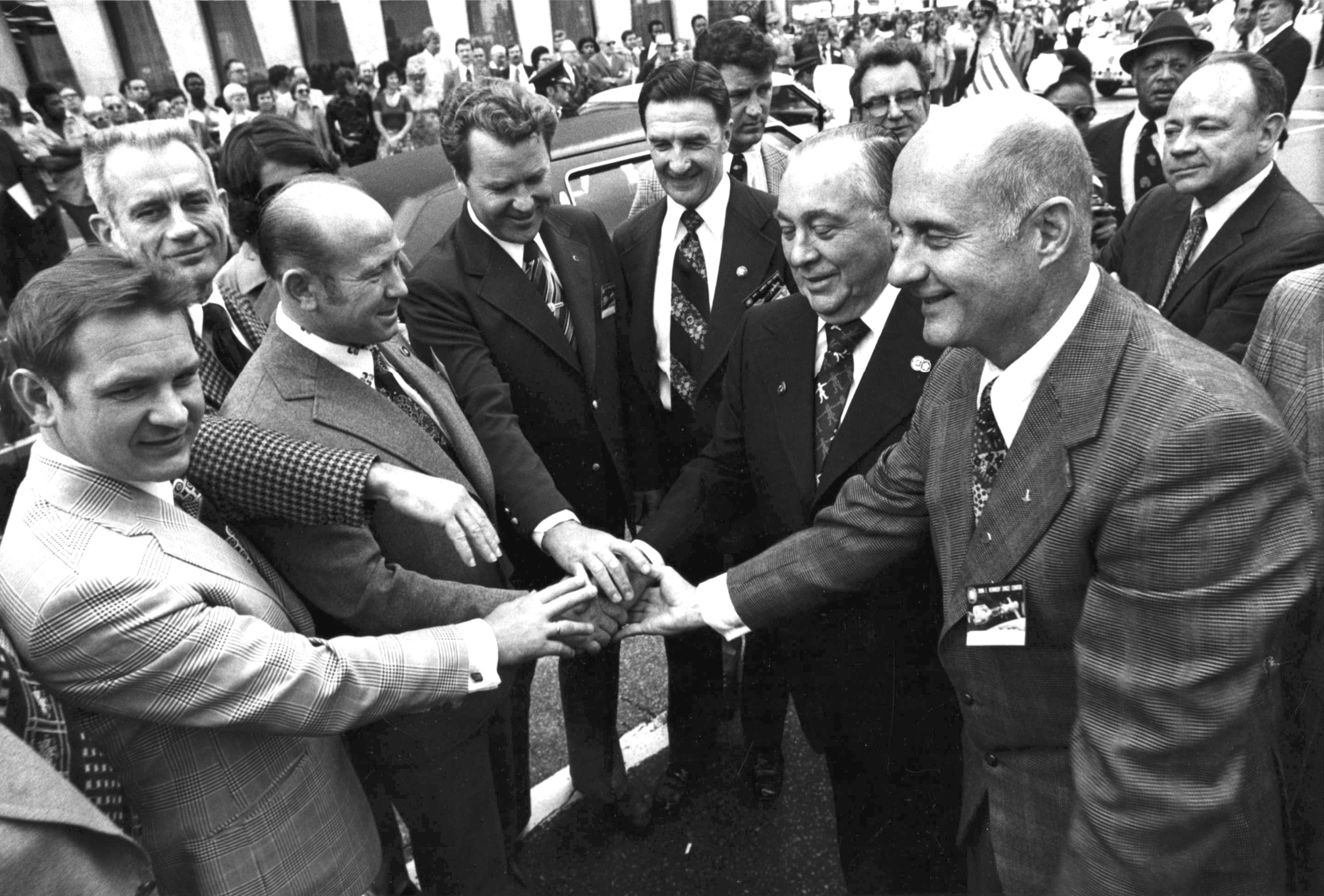 ◄ Members of the Russian and U.S. crews of the Apollo-Soyuz Test Project are honored October 1975 during a parade. Gen. Thomas P. Stafford, right, is joined by Chicago Mayor Richard Daly, second from right.