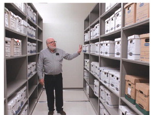 Phillip Fitzsimmons stands in the vault in the SWOSU library and shares about some of the items stored in the archive. Kimberly Lippencott/WDN