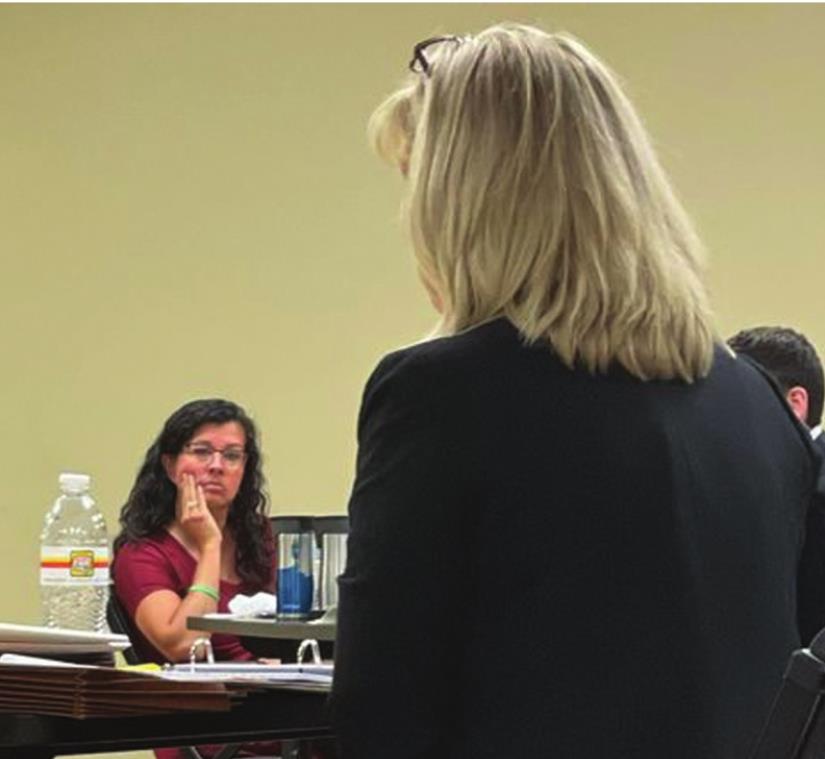 Jennifer Daniel, left, listens to witness testimony at her termination hearing Tuesday. Montgomery Malone/WDN