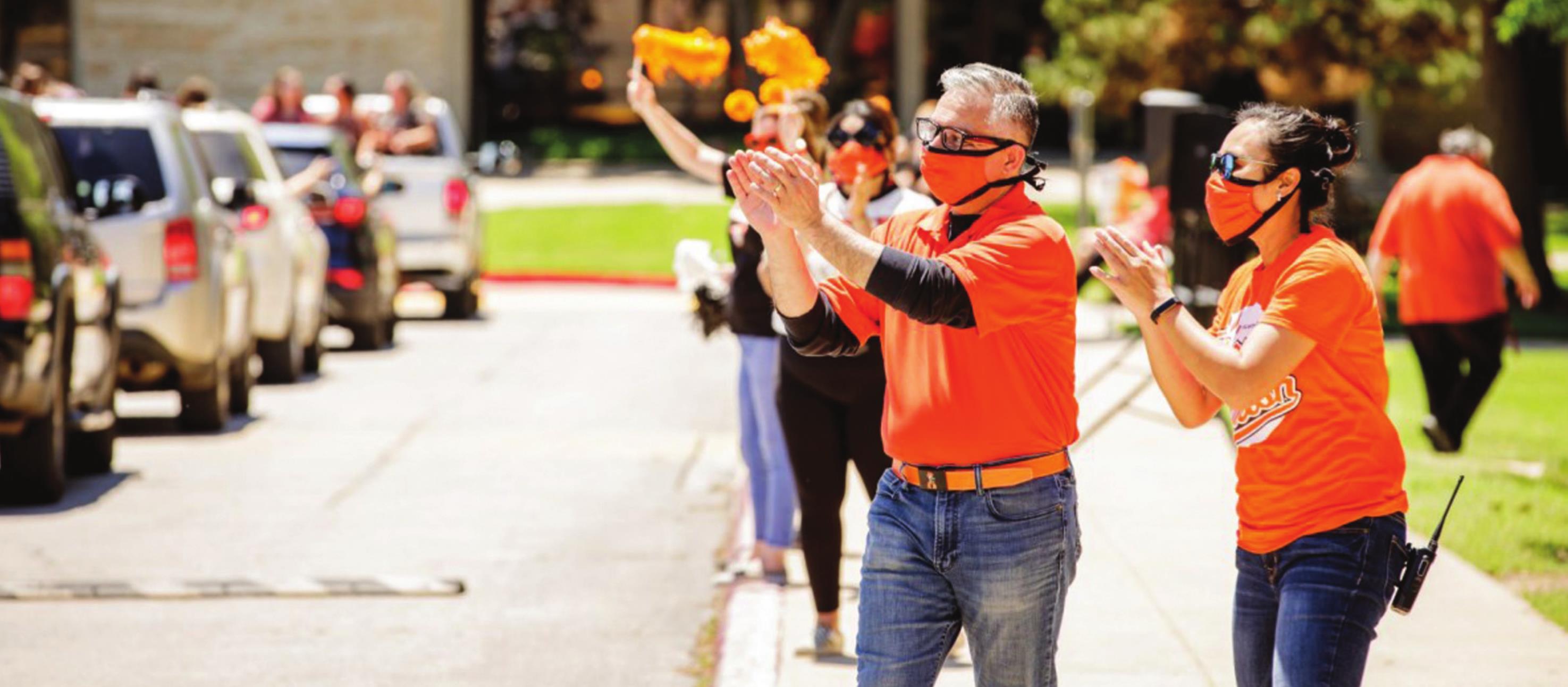 Oklahoma State University-Oklahoma City faculty and staff cheer students May 17 during a drive-through graduation celebration that replaced the traditional ceremony that could not be held because of COVID-19. Provided