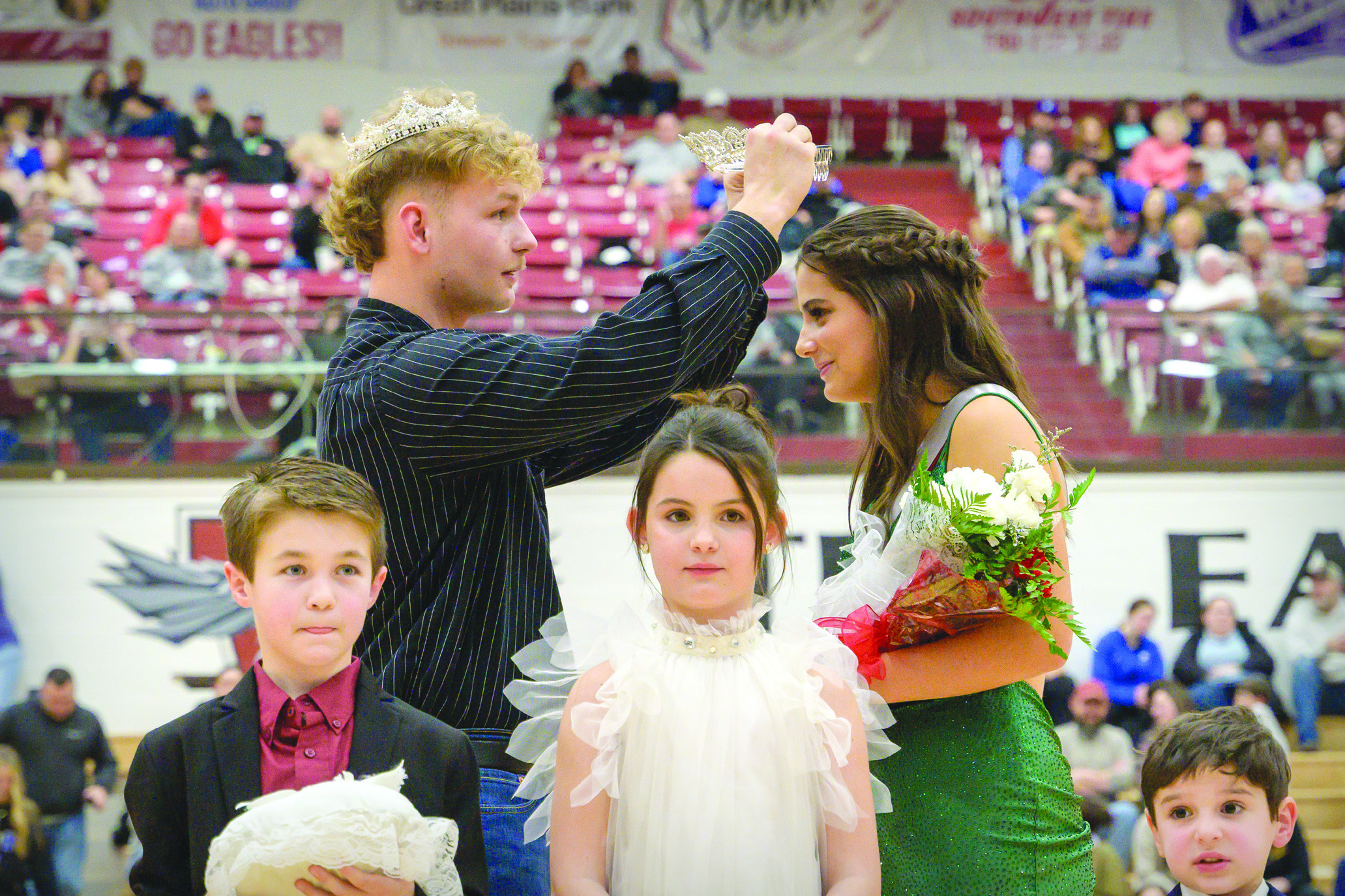 Homecoming King Cooper Madden crowns Homecoming Queen Mallory Miller. Photo by Kevin Fischer