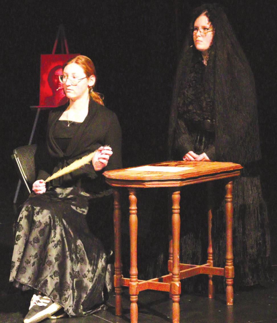 Sam Kellar, left, and Brittany Arnold play two haunting figures in Poe’s house in this stage adaption of “The Raven” by Edgar Allen Poe. Leanna Cook/WDN