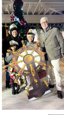Above left, Jessica Diaz stands by the wheel after winning a Winter Wonder Cruise.