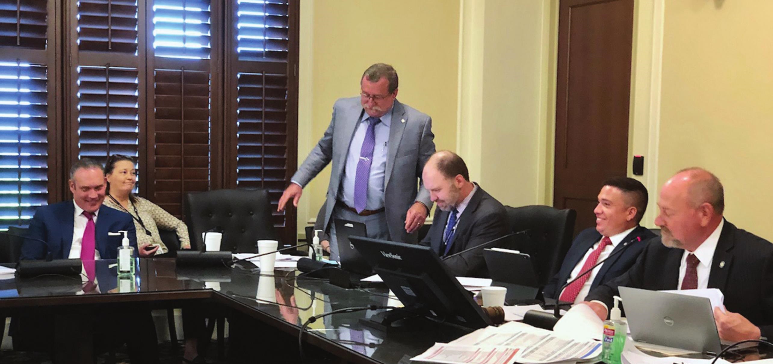 Flanked by members of house leadership, Rep. Mark McBride, R-Moore, takes his seat to present a bill after “ordering a dishwasher” on his cell phone Tuesday. Tres Savage/nondoc.com