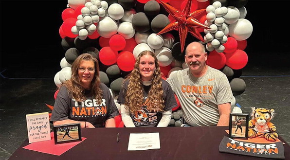 Dacey Morris, center, signs with Cowley College to play softball. She is pictured with her parents, Deb, left, and Rick.