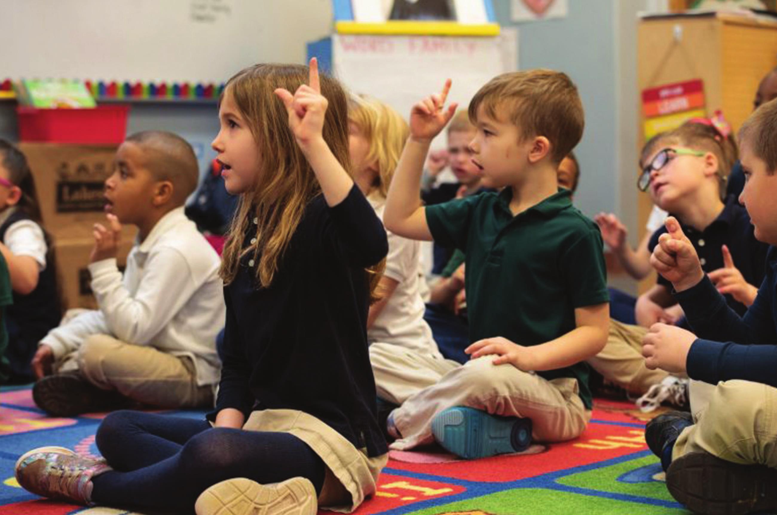 Kindergarteners at Nichols Hills Elementary School use hand motions as they sound out long and short vowels in Michelle Brooks’ class. Whitney Bryen/Oklahoma Watch